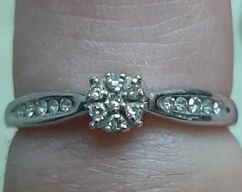 A vintage 9ct white gold diamond cluster ring