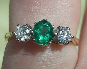 A vintage 18ct yellow gold emerald and diamond three stone ring