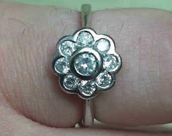 A vintage 18ct white gold diamond daisy cluster ring