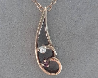A vintage ruby and diamond pendant, on a 9ct gold chain