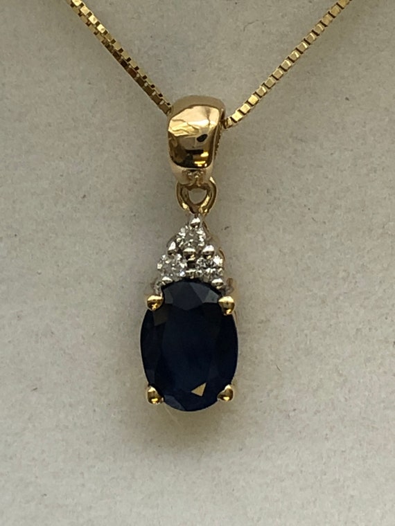 A 9ct gold sapphire and diamond pendant - image 2