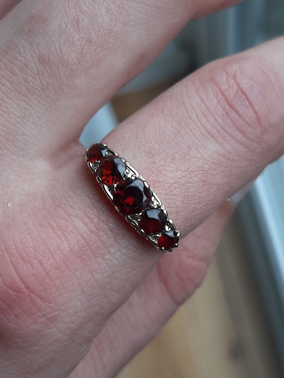 A vintage 9ct gold garnet five stone ring