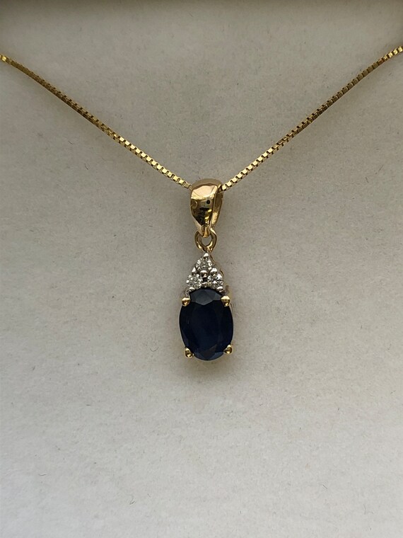 A 9ct gold sapphire and diamond pendant - image 1