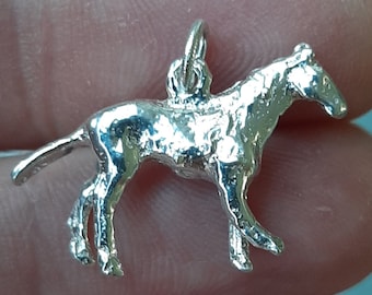 A silver horse pendant charm