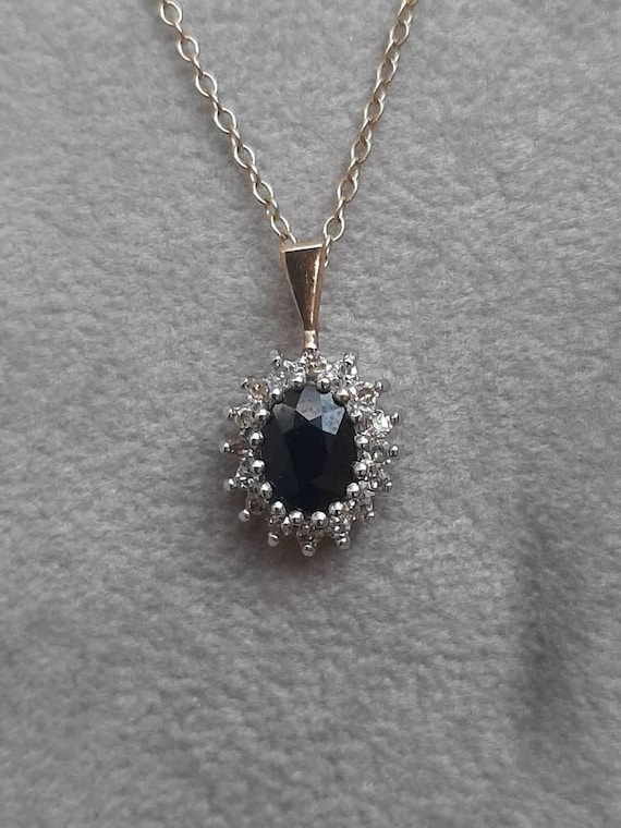 A vintage 9ct gold sapphire and diamond pendant on