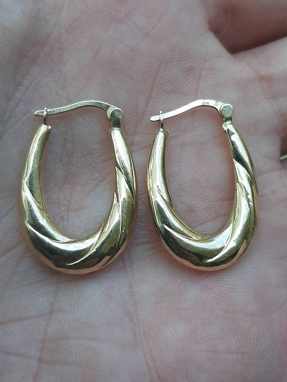 A vintage pair of 9ct gold hoop earrings - image 1