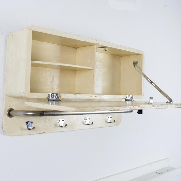 Vintage wooden bathroom cabinet. Vintage wall kitchen shelf with metal hooks. Rustic wall cabinet