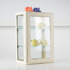 Vintage glass bathroom cabinet with red cross. Medical wall cabinet. Metal medicine bath cabinet. Vintage glass door wall cabinet.