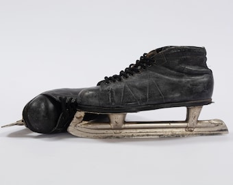 Vintage black hockey men's ice skates. Vintage ice hockey leather skates. Retro men's black leather sport boots USSR. Ice skates 1960s.