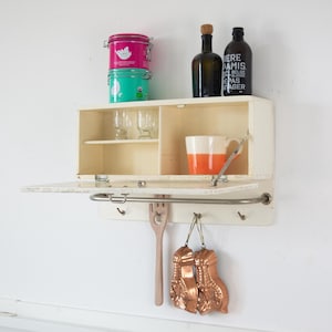 Vintage wooden bathroom cabinet. Vintage wall kitchen shelf with metal hooks. Rustic wall cabinet