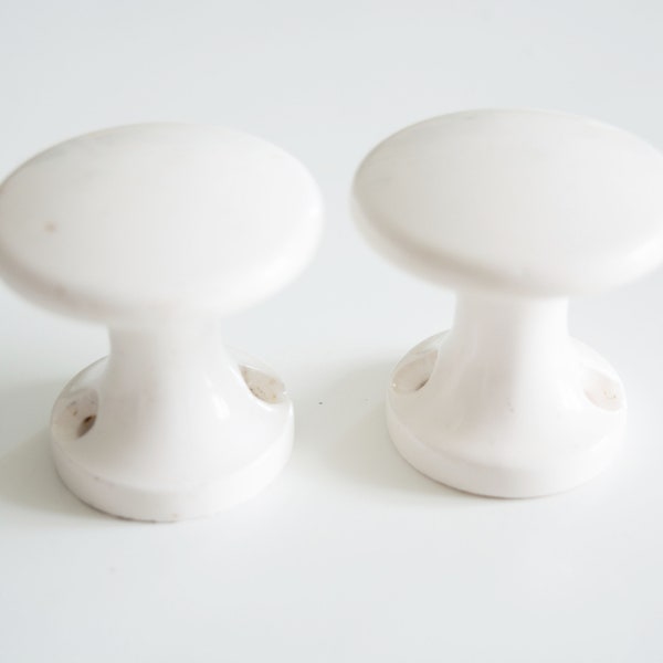 White ceramic doorknobs. Pair of vintage porcelain furniture handles for decoration. Shabby chic doorknob set