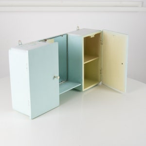Vintage white wooden bathroom cabinet with mirror. Retro bathroom cabinet 1960s. Industrial bathroom vanity wall cabinet with mirror.