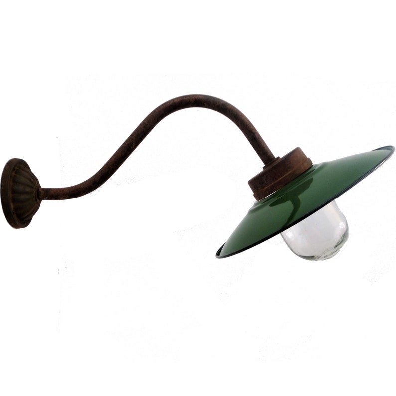 May include: A vintage green metal wall lamp with a curved arm and a clear glass globe. The lamp has a rusty finish and is perfect for adding a touch of industrial style to any space.