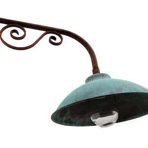 May include: A vintage, rusty metal outdoor light fixture with a teal green, dome-shaped shade and a clear glass globe.