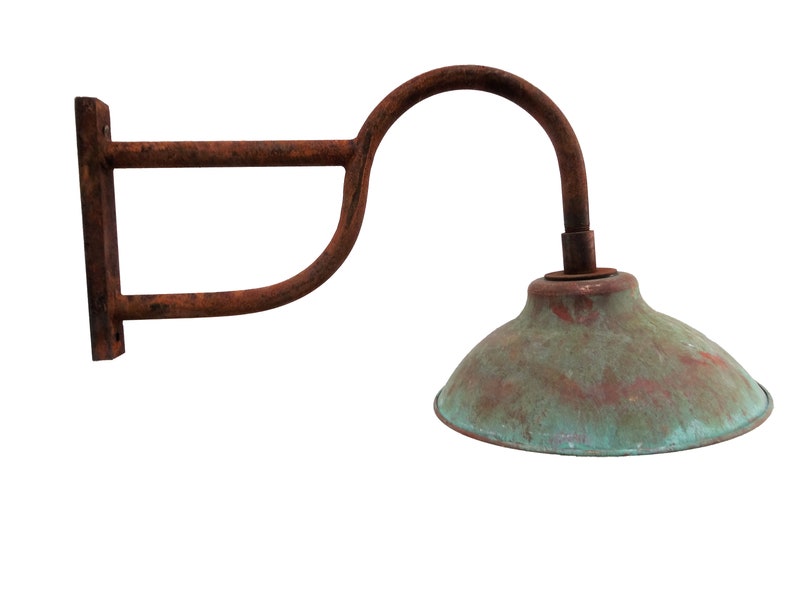 May include: A rusty metal wall sconce with a curved arm and a green copper-colored lampshade.