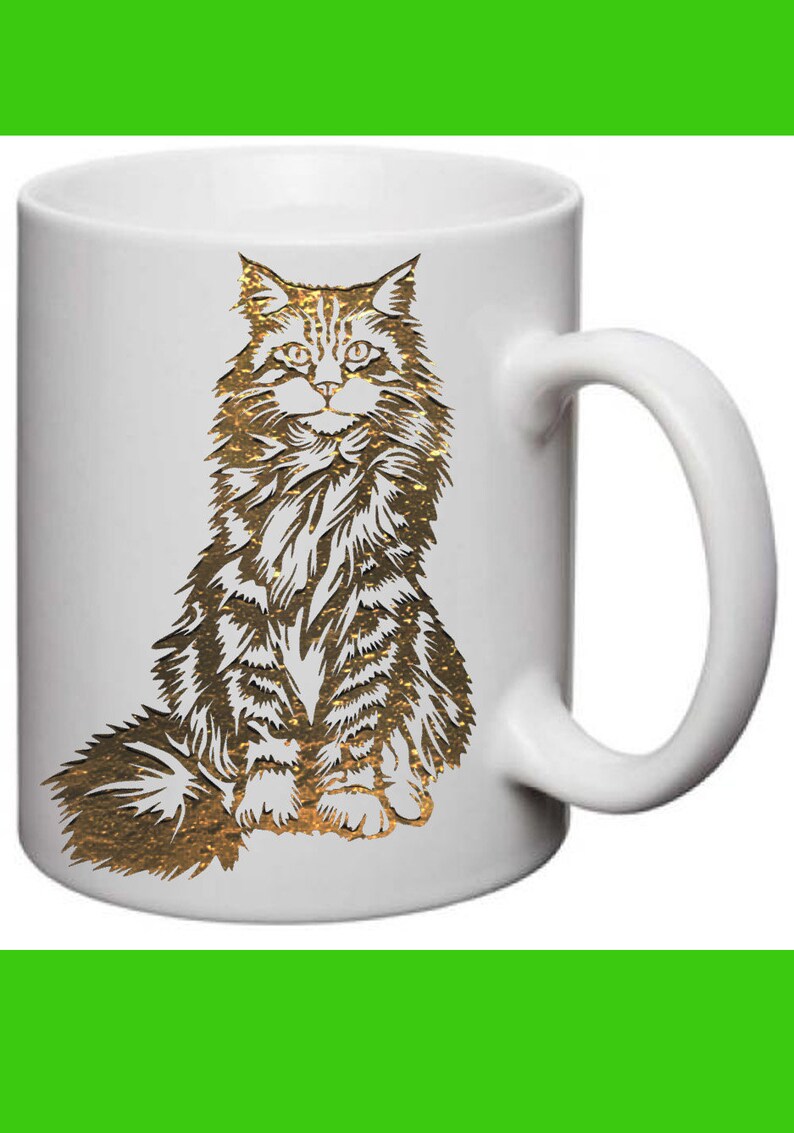 May include: White ceramic mug with a gold-colored illustration of a Maine Coon cat sitting on its haunches.