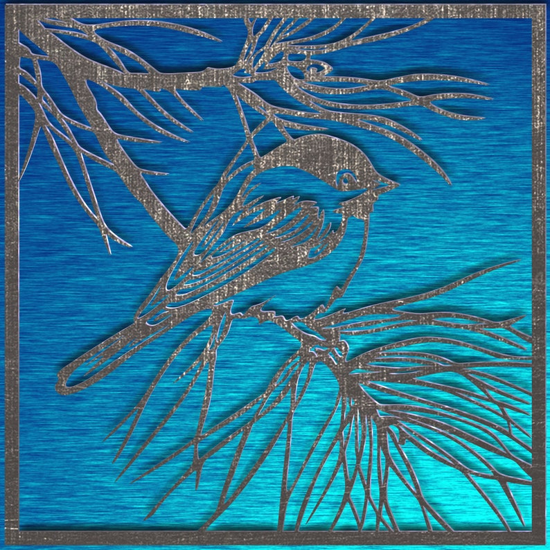 May include: A silver-colored, laser-cut bird perched on a branch, set against a vibrant blue background. The artwork features intricate details of the bird and foliage, framed within a square border. The design has a textured, metallic appearance.