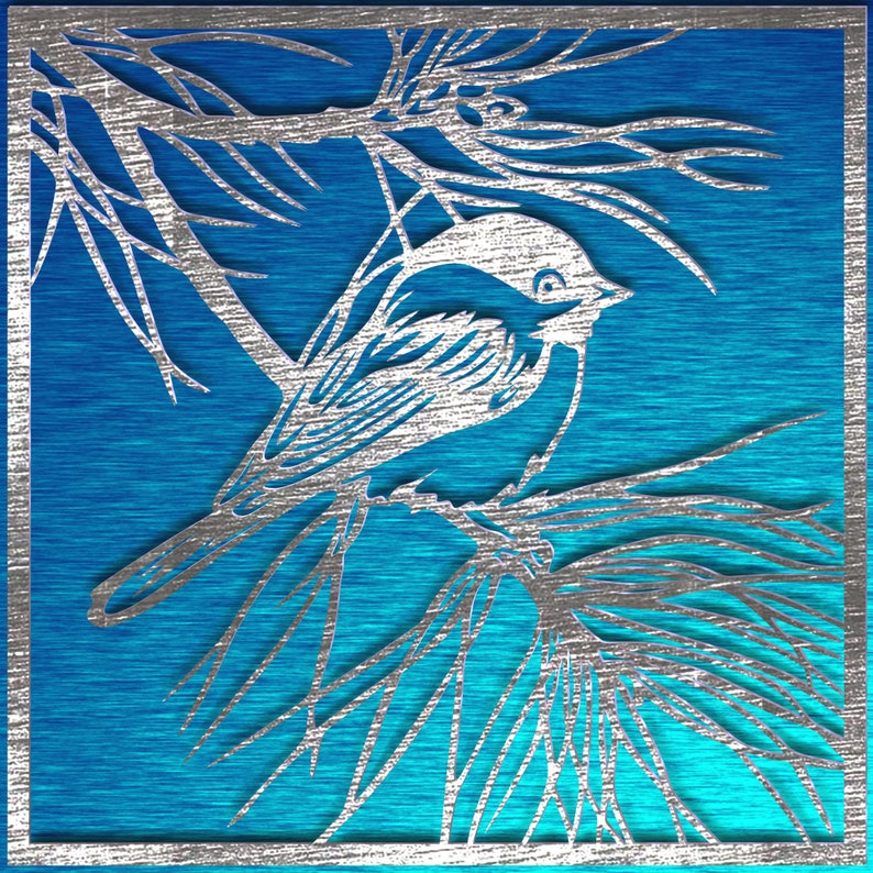 May include: A silver-colored, laser-cut bird perched on a branch, set against a vibrant blue background. The artwork features intricate details of the bird and foliage, framed within a silver border. The blue background has a brushed metal texture.