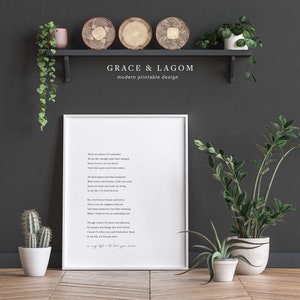 May include: A white framed printable with a poem about remembering people and places. The poem is titled "Grace & Lagom" and is set against a dark gray background with a shelf and plants.