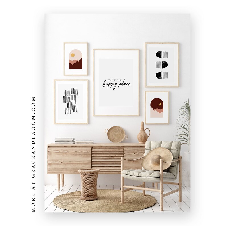 May include: A gallery wall featuring framed art prints with minimalist designs and the phrase "this is our happy place." The art includes abstract shapes and landscape scenes in neutral tones. A wooden cabinet, chair, and decor complete the room.