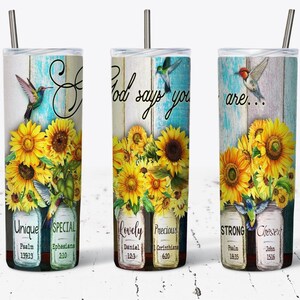 May include: Three stainless steel tumblers with a rustic wood background and sunflower designs. Each tumbler has a different inspirational quote and bible verse. The quotes are "God says you are...", "Unique", and "Special".