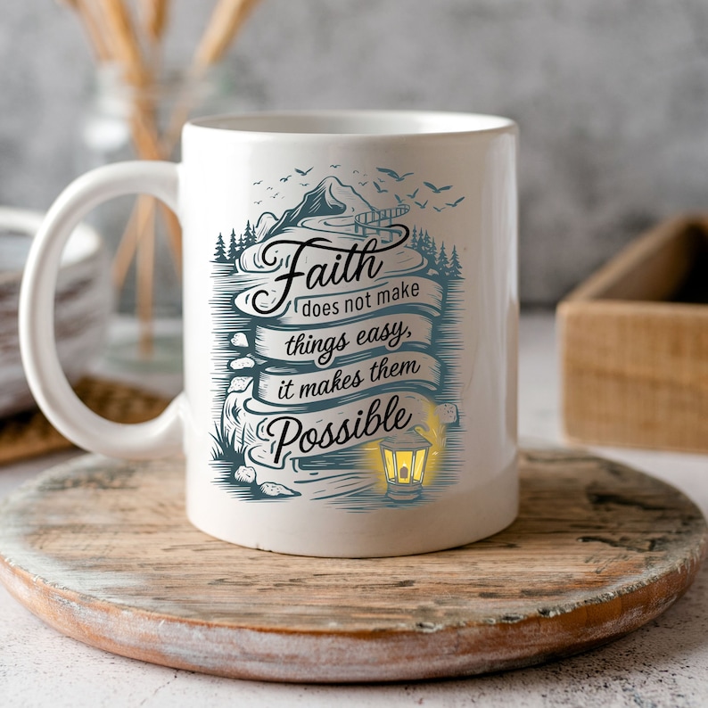 May include: White ceramic coffee mug with a blue and white design featuring a mountain scene and the text "Faith does not make things easy, it makes them possible".