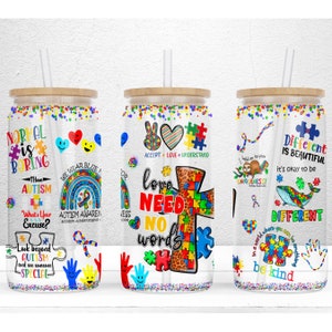 May include: Three clear tumbler cups with bamboo lids and straws. Each cup features a different design with puzzle pieces, hearts, and the words "Love Need No Words", "Different is Beautiful", and "Normal is Boring".