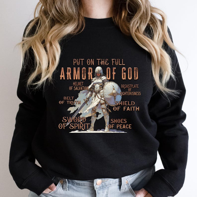 May include: Black sweatshirt featuring a graphic of a knight in armour and the text "Put on the full Armour of God" with the different parts of the armour labelled.