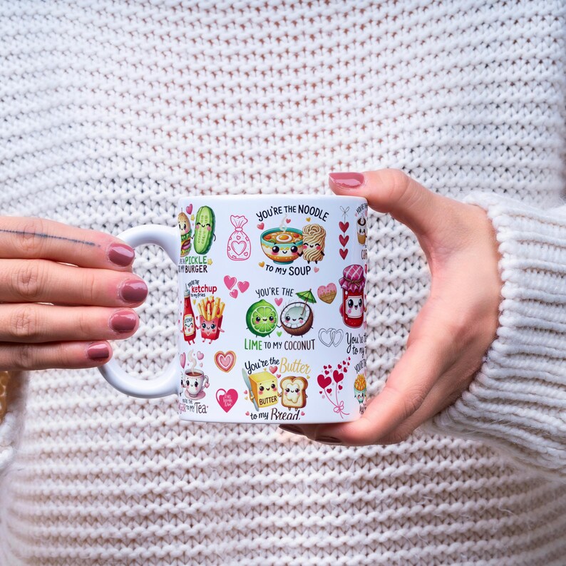 May include: White ceramic mug with a variety of food-themed illustrations and text. The mug features images of a pickle burger, ketchup, noodles, lime, coconut, butter, and bread, along with phrases like "You're the Noodle to my Soup."
