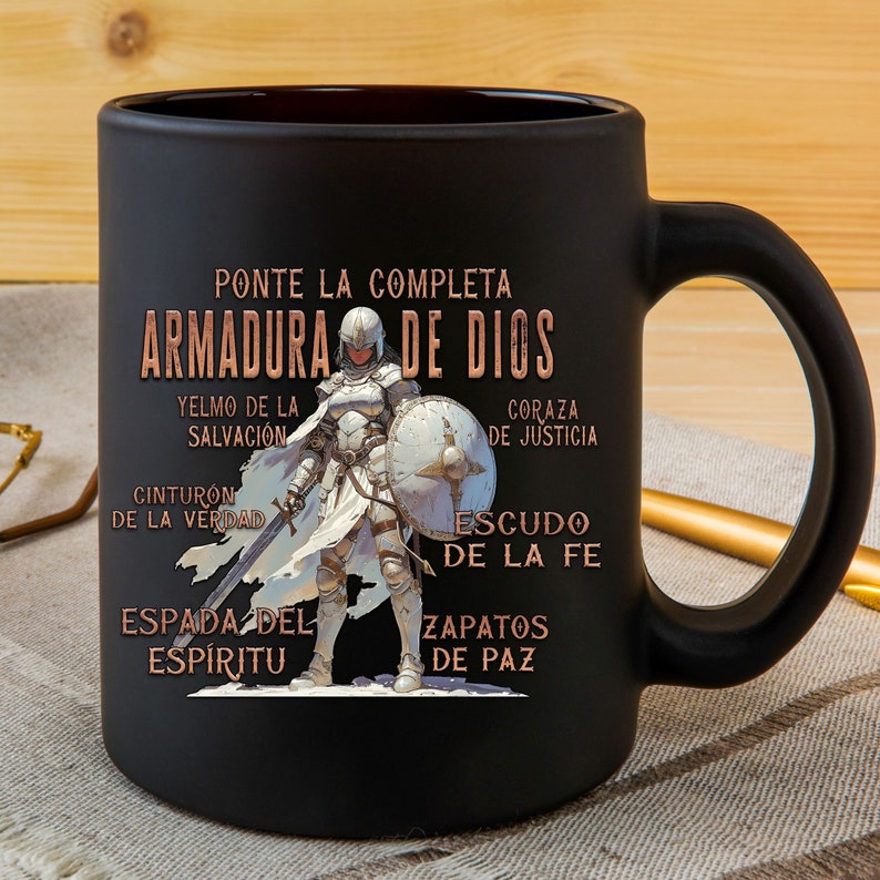 Pode incluir: Caneca de cer&acirc;mica preta com um design branco e dourado que apresenta uma mulher com armadura e o texto "PONTE LA COMPLETA ARMADURA DE DIOS" com as palavras "YELMO DE LA SALVACI&Oacute;N", "CINTURON DE LA VERDAD", "ESPADA DEL ESP&Iacute;RITU", "CORAZA DE JUSTICIA", "ESCUDO DE LA FE" e "ZAPATOS DE PAZ" ao redor da imagem.