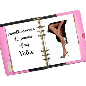May include: An open pink and black planner with a white page that says "Humble as ever, but aware of my Value". The right page has a drawing of a woman's legs in high heels.