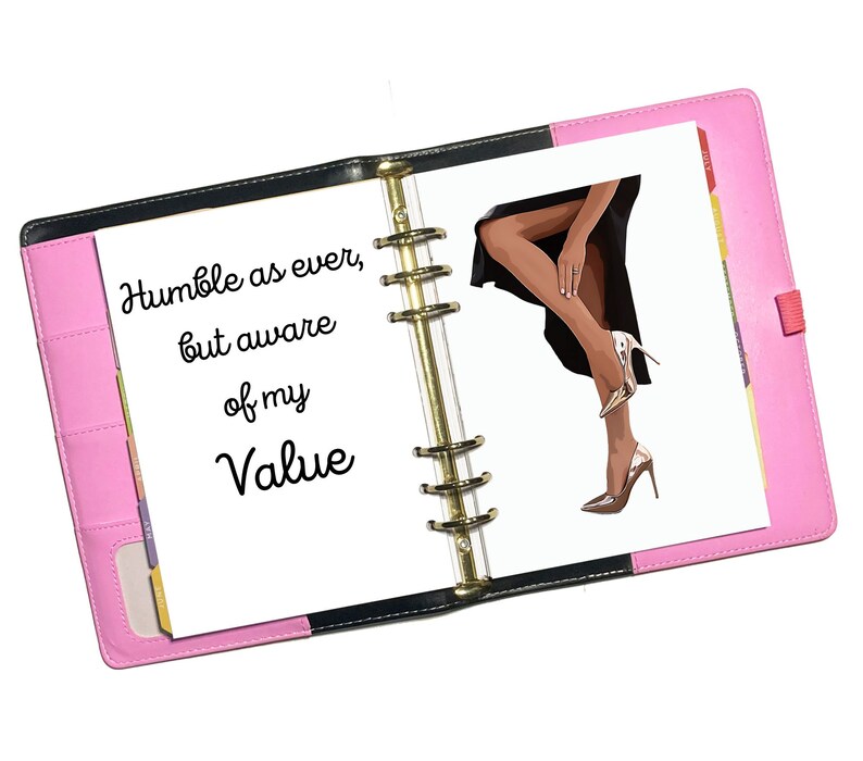 May include: An open pink and black planner with a white page that says "Humble as ever, but aware of my Value". The right page has a drawing of a woman's legs in high heels.