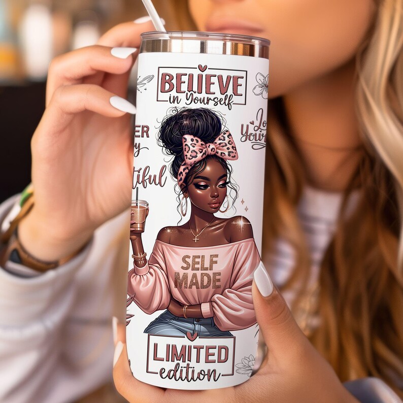 May include: A white tumbler with a pink and black illustration of a woman with the text "Believe in Yourself", "Love Yourself", "Self Made", and "Limited Edition".