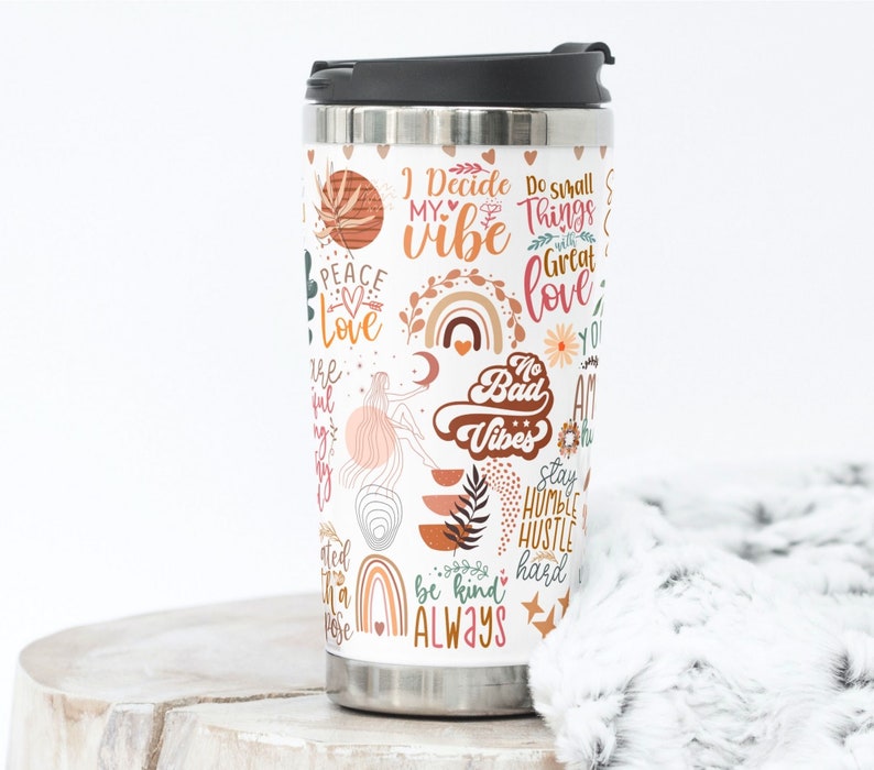 May include: A stainless steel travel mug with a white background and colorful graphics. The graphics include text such as "I Decide My Vibe", "Do Small Things With Great Love", "No Bad Vibes", "Stay Humble Hustle Hard", and "Be Kind Always".