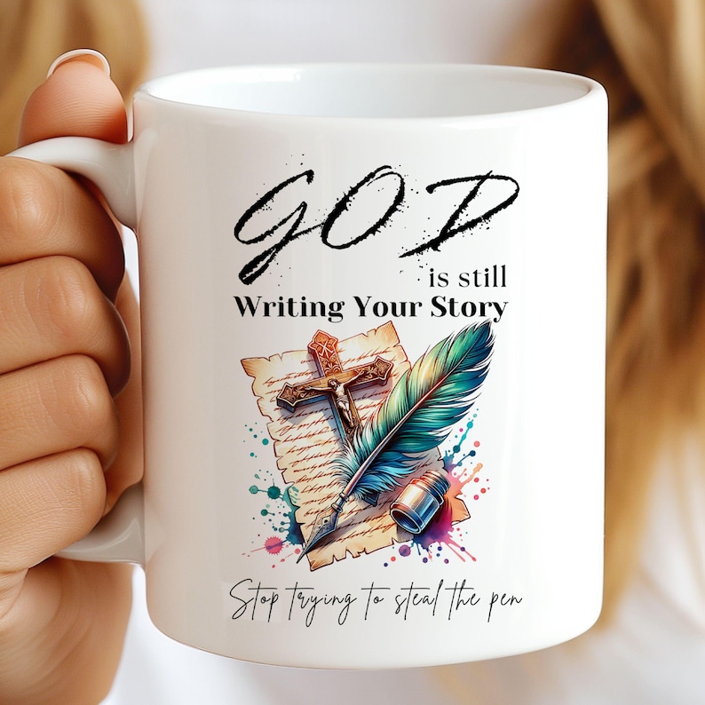 Create a meaningful Christian mug with this God Is Still Writing Your Story design. Featuring a cross, feather, and quill, it's perfect for inspirational gifts and daily reminders of faith.