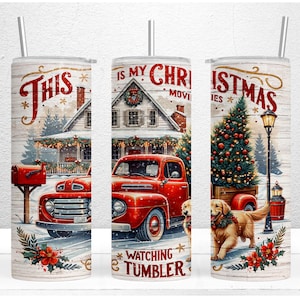 May include: A red truck with a Christmas tree in the back, a golden retriever dog, and a house with a wreath on the door. The text "This is my Christmas Movie Watching Tumbler" is on the tumbler.
