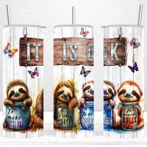 May include: Three stainless steel tumblers with a white woodgrain background. Each tumbler features a sloth holding a mason jar with a motivational quote. The quotes are "To make mistakes", "To take a break", and "To be yourself". The tumblers also feature butterflies and a wooden sign that says "It is ok".