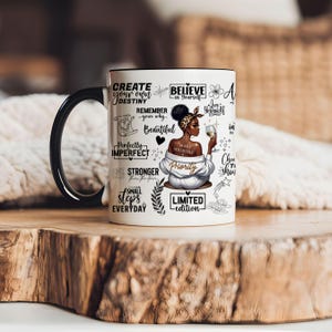 May include: White ceramic mug with a black handle. The mug features a black and white illustration of a woman with a crown of flowers and a glass of wine. The mug is decorated with inspirational quotes, including "Create your own destiny", "Believe in yourself", "Love yourself", "Make yourself a priority", "Perfectly imperfect", "Stronger from the storm", "Small steps everyday", and "Limited edition".
