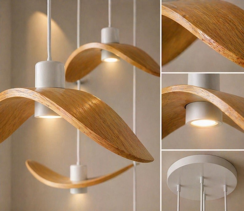 May include: Modern pendant lights with a curved, wooden shade and a white base. The lights hang from white cords and emit a warm glow. The wooden shades have a natural wood grain finish.