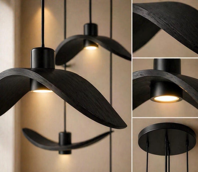 May include: Three black, modern pendant lights with a unique, curved design. Each light features a circular base with a downward-facing, warm-toned light. The lights are suspended from the ceiling by thin black cords, creating a stylish and contemporary look.