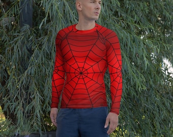 May include: A red long-sleeved top featuring a black spiderweb pattern. The top is paired with navy blue shorts. The design covers the chest, back, and arms, creating a superhero-inspired look. The top has a crew neck.
