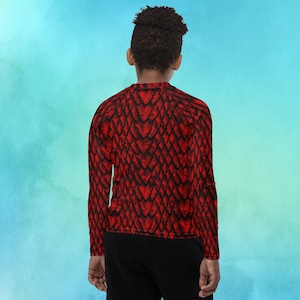 May include: A red long-sleeved shirt with a dragon scale pattern.