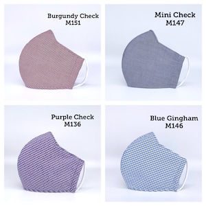 May include: Four different patterned face masks. The masks are all the same style, with a white elastic band and a white nose wire. The masks are in the following colors and patterns: burgundy check, mini check, purple check, and blue gingham.