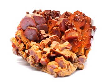 May include: A cluster of vibrant, orange-red vanadinite crystals. The mineral formation features a complex arrangement of hexagonal prisms and smaller, cubic crystals. The crystals have a glossy, reflective surface, and the base is a rough, earthy brown.