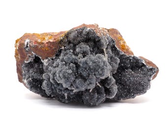May include: A close-up of a mineral specimen featuring a dark gray, crystalline structure clustered on a reddish-brown matrix. The mineral has a textured, almost bubbly appearance, with small, sparkling crystals.