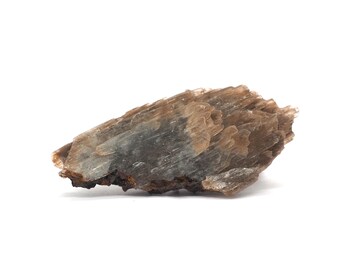 May include: A natural mineral specimen with a layered, crystalline structure. The stone features a blend of brown, tan, and translucent gray hues. The rough, irregular edges and overall shape suggest it is a raw, unpolished geode or crystal.