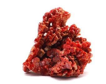 May include: A cluster of red, orange, and brown crystals with a rough, textured surface. The crystals are arranged in a random, organic pattern, creating a unique and interesting display.
