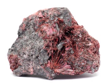 May include: A rough-hewn mineral specimen featuring a mix of dark gray and deep red hues. The rock's surface is textured, with crystalline formations of a vibrant red color. The overall appearance suggests a natural, unrefined gemstone.