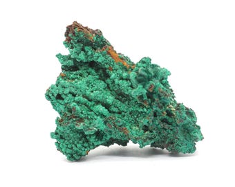 May include: A vibrant green malachite mineral specimen with a textured, crystalline surface. The stone has areas of brown and orange oxidation. The mineral is displayed against a white background.
