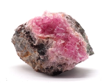 May include: A pink and gray rock with a cluster of pink crystals. The crystals are sharp and have a glassy luster.